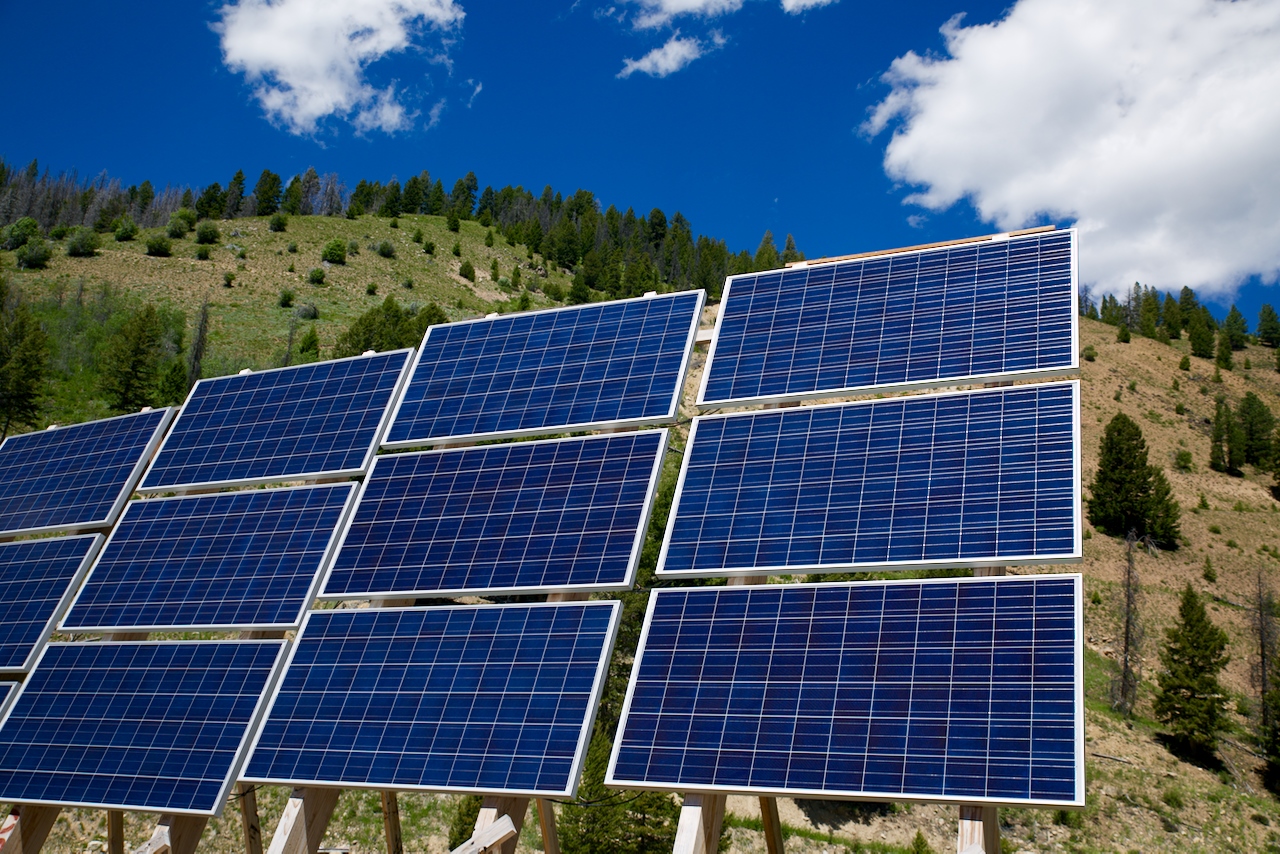 A solar panel array on an Idaho hillside under a blue sky