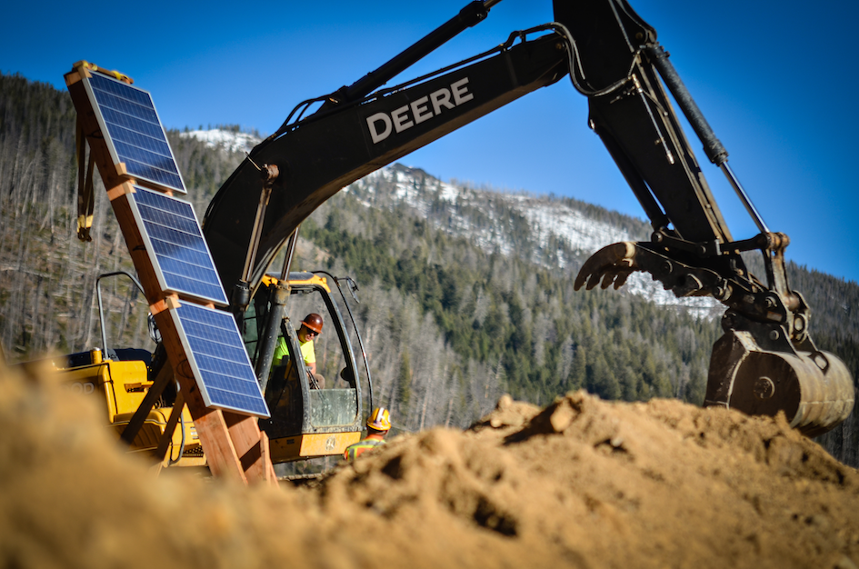 Backhoe loader operating in field