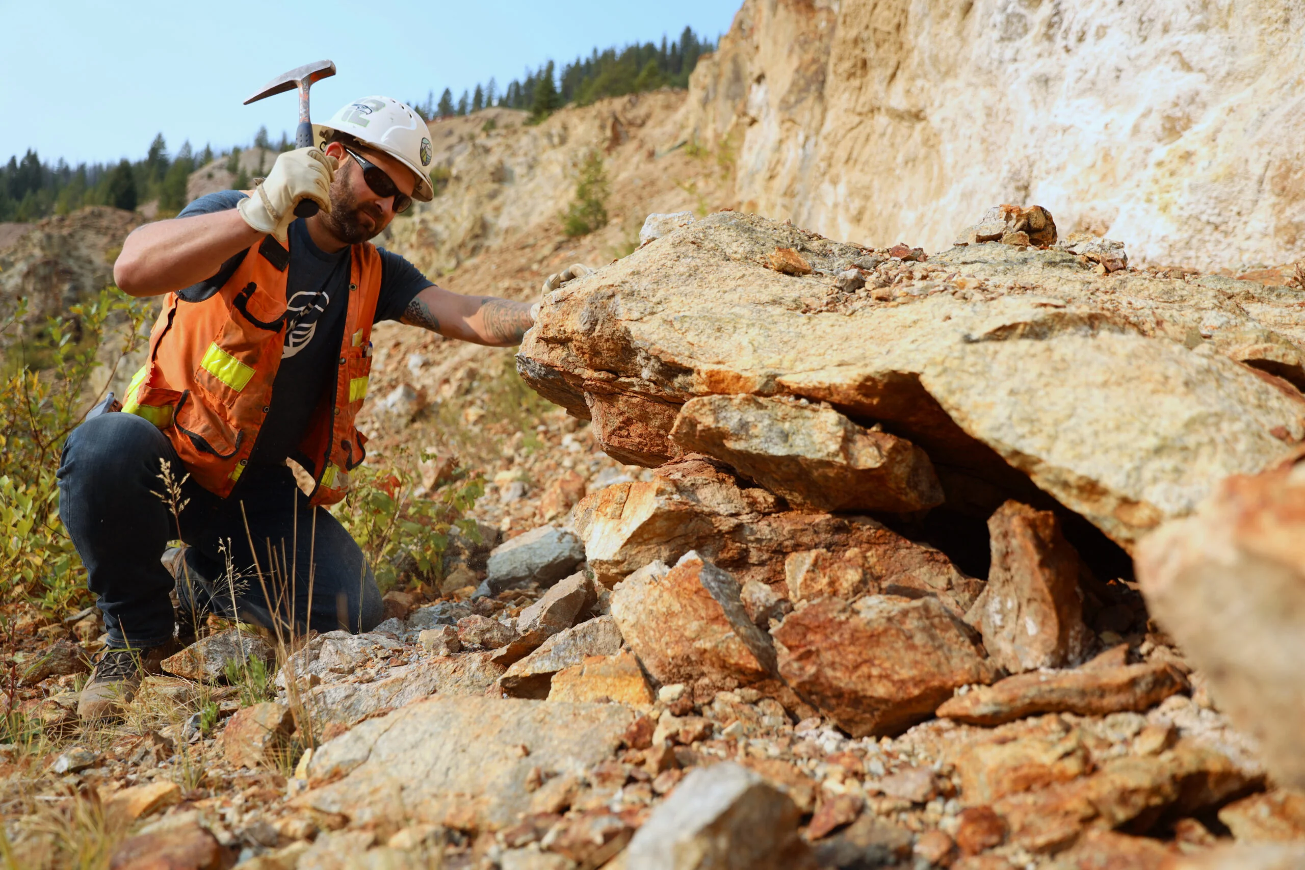 Worker hammering at a rock