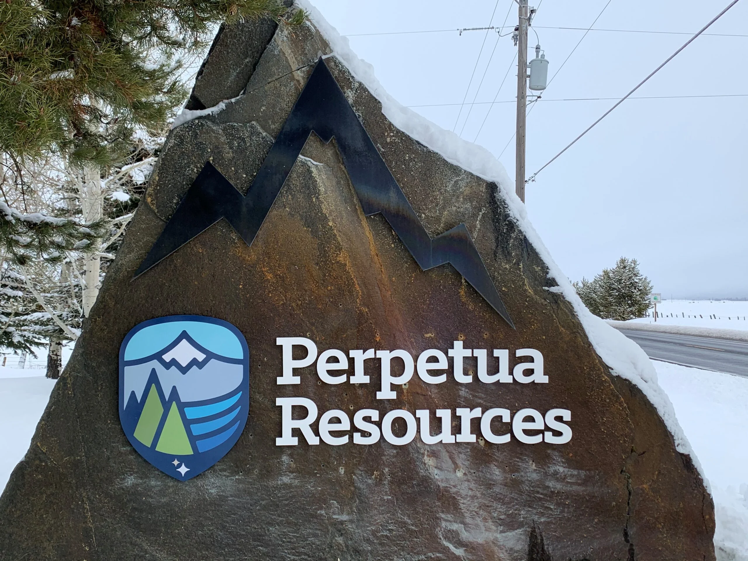 The Perpetua Resources logo on a tall rock