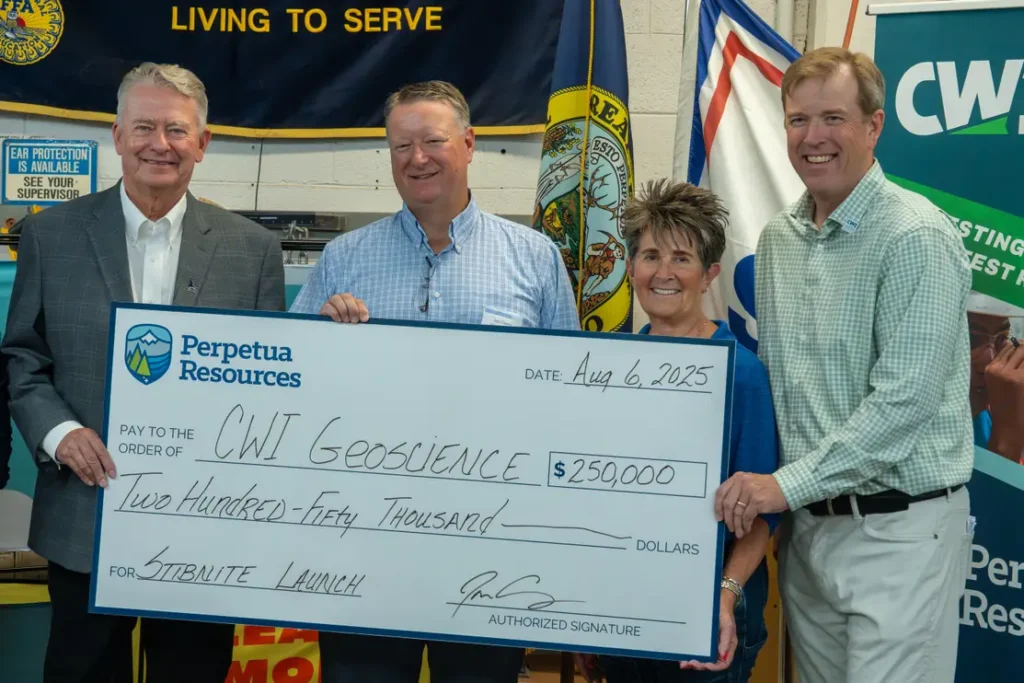 Leadership holding up a check