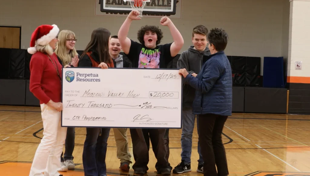 Students holding up a check from Perpetua Resources